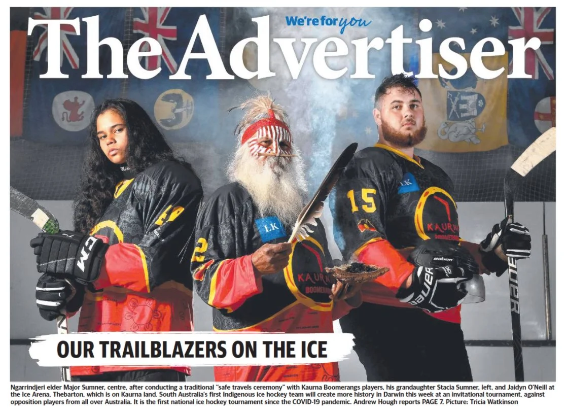 The Advertiser front page featuring two Kaurna Boomerangs ice hockey players with an Indigenous elder during a traditional ceremony, highlighting the team as trailblazers on the ice.