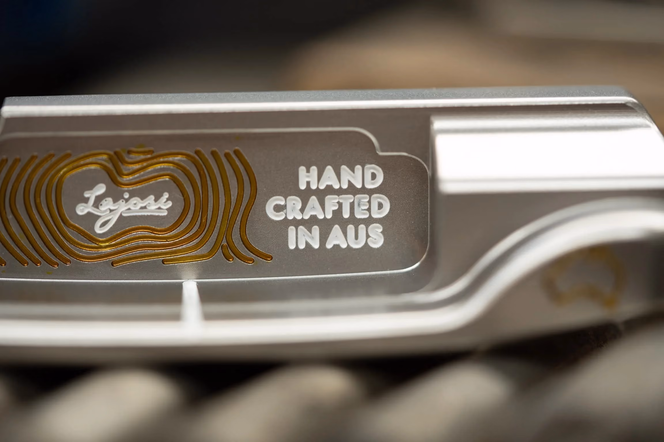 Close-up of a precision-milled Lajosi putter engraved with the logo and ‘Hand Crafted in Aus,’ reinforcing the brand’s Australian workshop heritage and handmade quality.