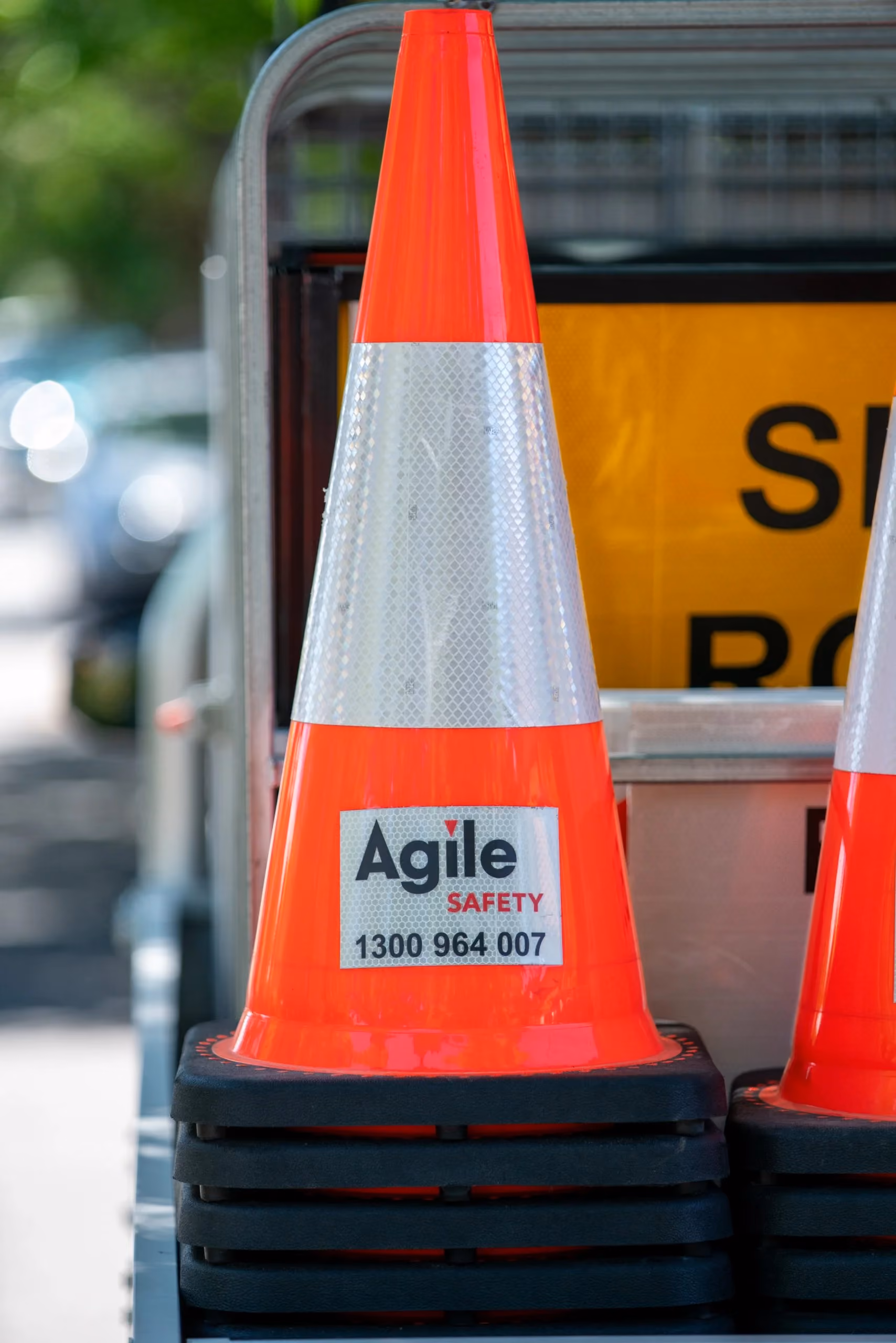 Stacked Agile Safety traffic cones and roadside signage, showing the division’s practical equipment, clear branding and connection to the wider Agile Group identity.