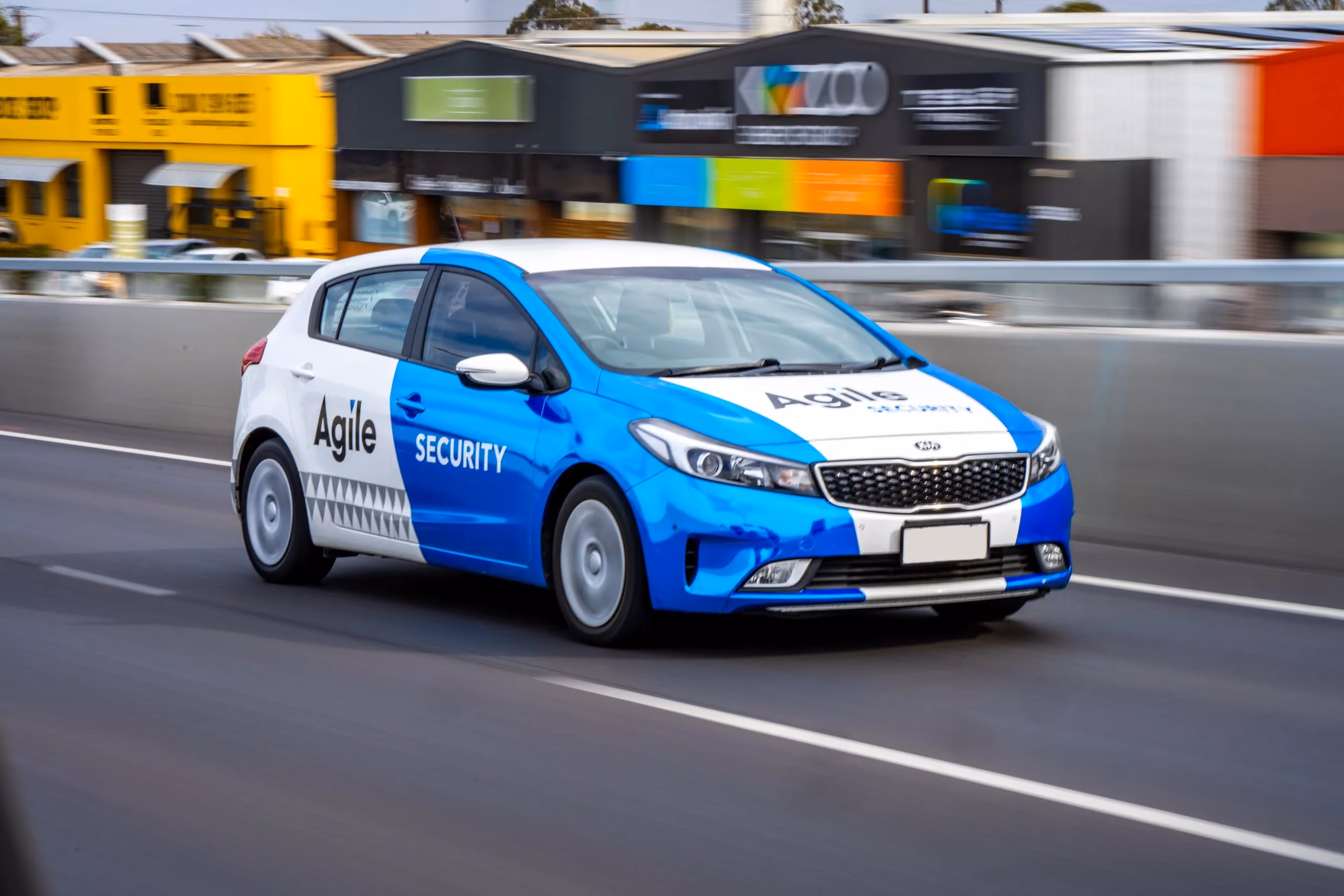 Agile Security branded vehicle on the road, showing how the division retained a clear service identity while remaining visibly connected to the wider Agile Group brand.