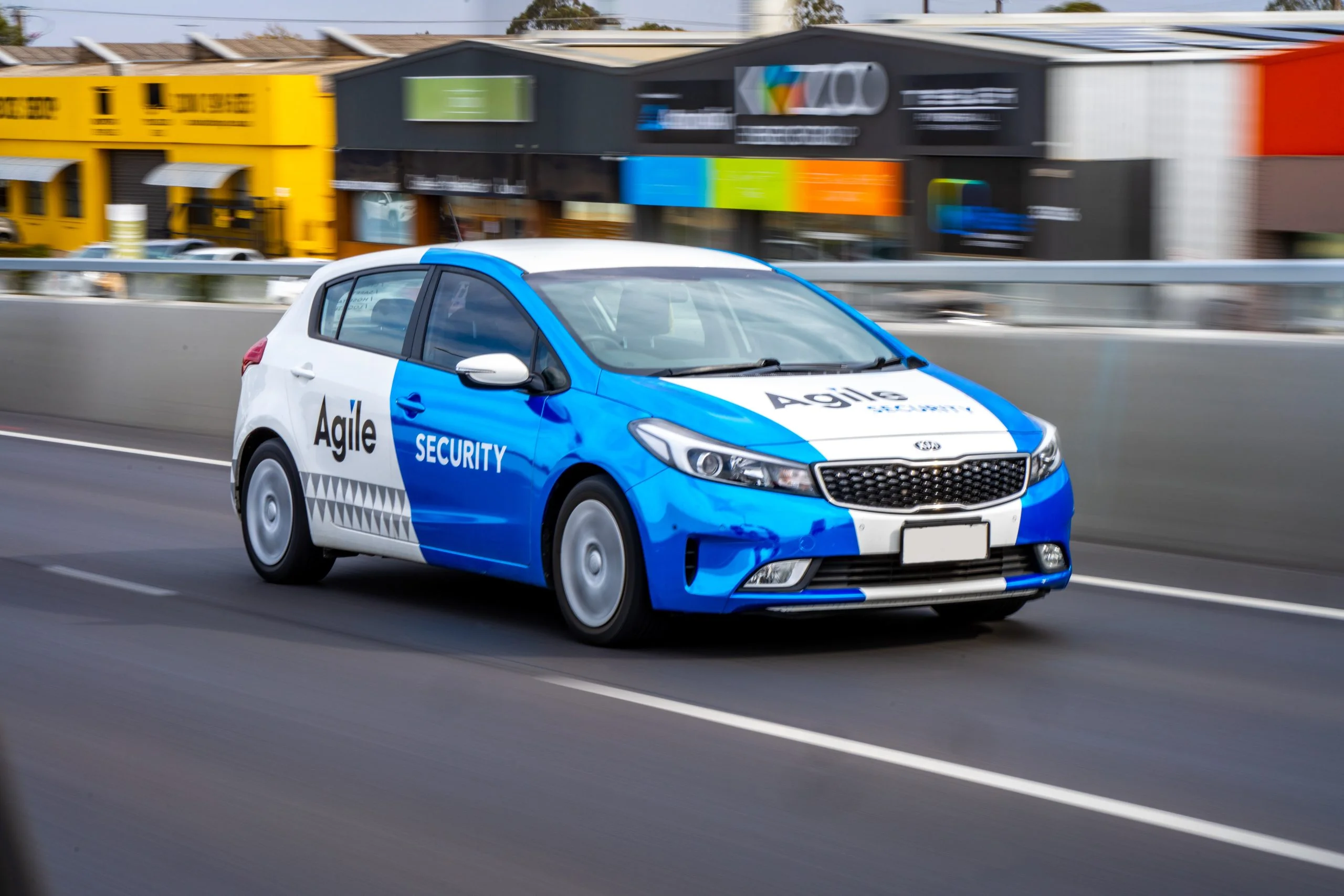 Agile Security branded vehicle on the road, showing how the division retained a clear service identity while remaining visibly connected to the wider Agile Group brand.