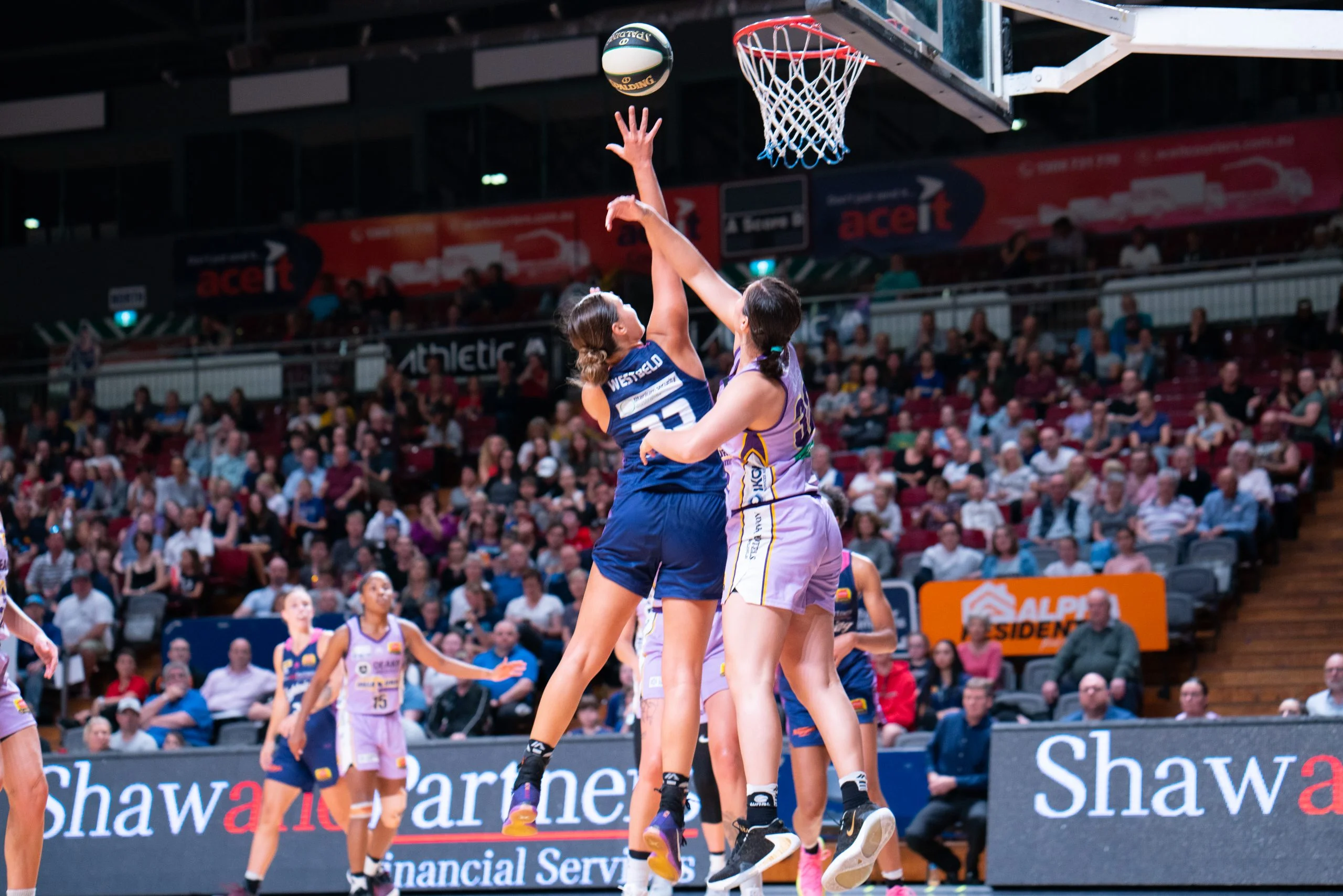 Adelaide Lightning players in action against the Melbourne Boomers