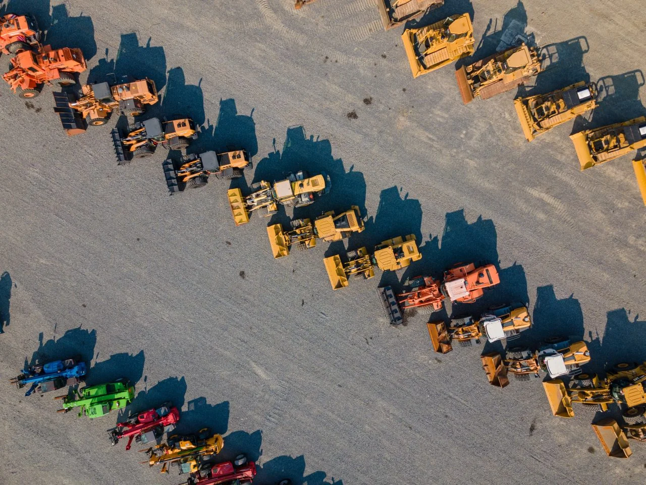 Aerial view of wheel loaders, bulldozers and telehandlers arranged across a large equipment yard, demonstrating Mine Services Holdings’ fleet range, scale and readiness for mining and civil projects.