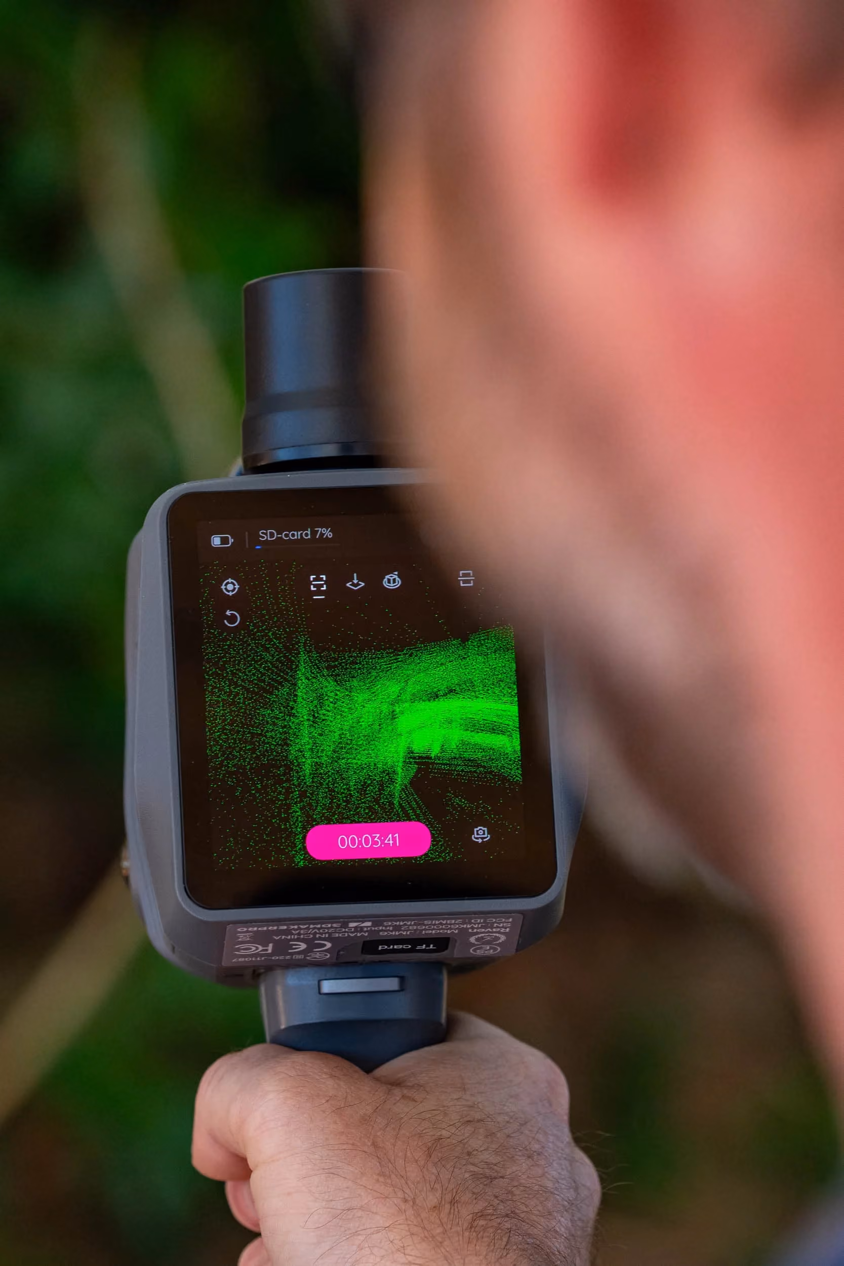 Perth Surveying team member operates a handheld 3D laser scanner displaying a live point-cloud model, highlighting the technical capability and precise data collection behind its surveying work.