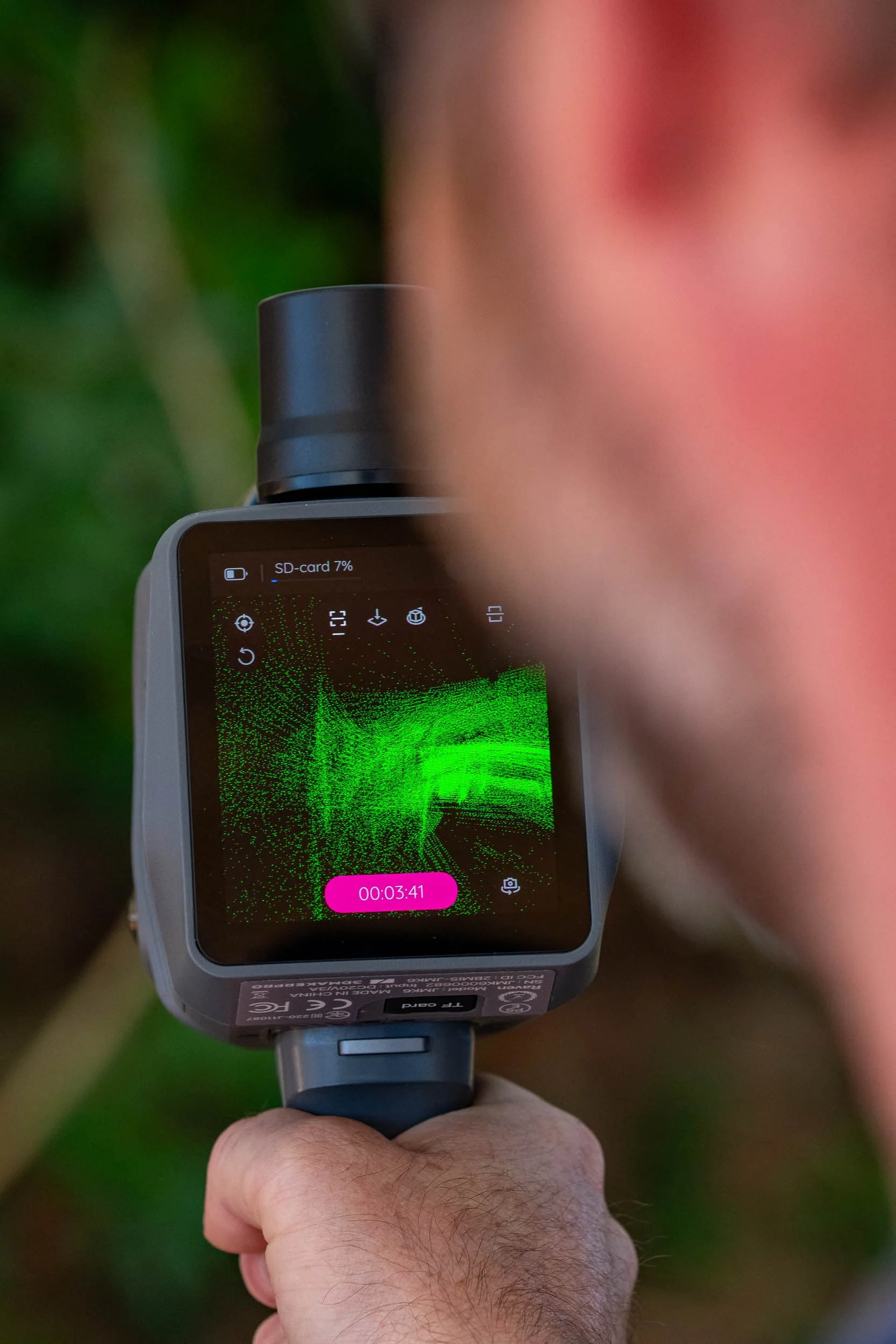 Perth Surveying team member operates a handheld 3D laser scanner displaying a live point-cloud model, highlighting the technical capability and precise data collection behind its surveying work.