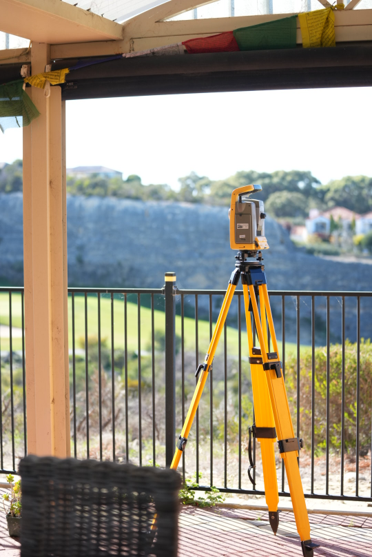 Surveying total station mounted on a tripod at a residential property, showing the precise field equipment Perth Surveying uses to support reliable planning, boundary and development work.