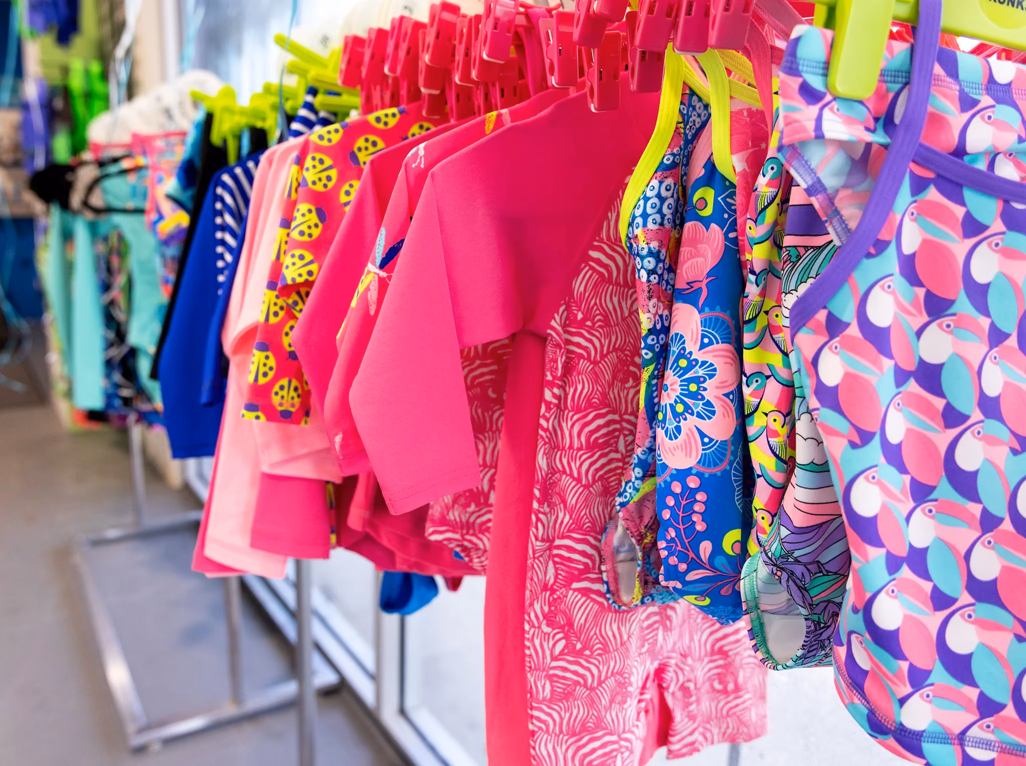 Colourful children’s swimwear displayed on a rack at WaterPonyz, reflecting the family-focused environment and practical support surrounding the school’s swimming lesson experience.