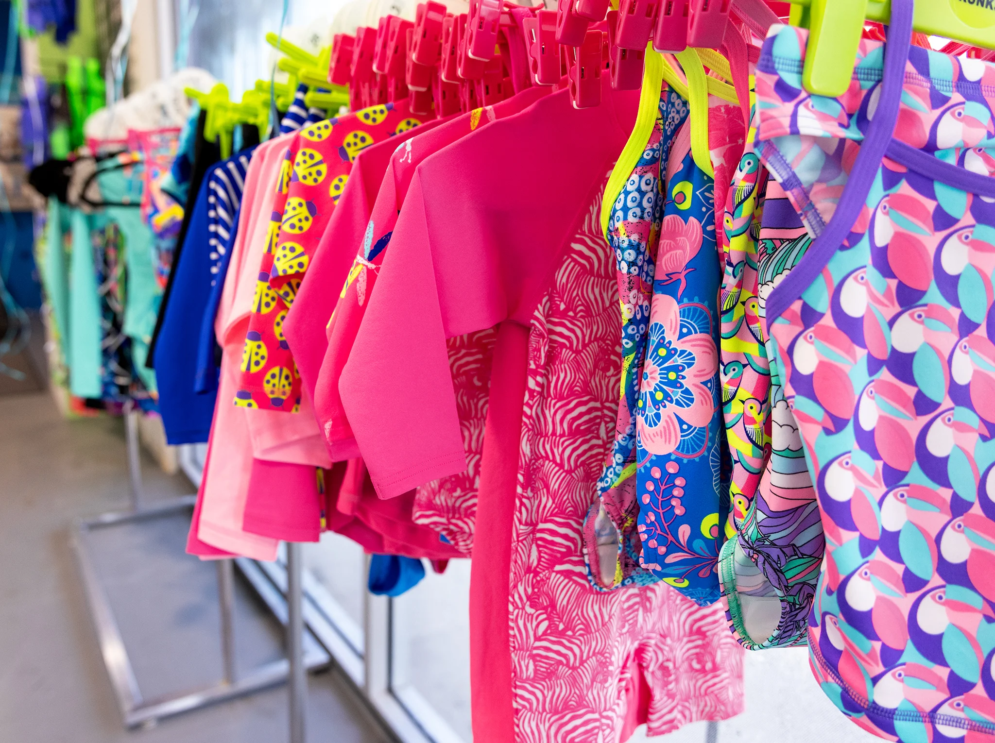 Colourful children’s swimwear displayed on a rack at WaterPonyz, reflecting the family-focused environment and practical support surrounding the school’s swimming lesson experience.