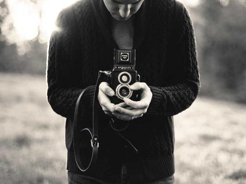 Photographer holding a camera for a studio business
