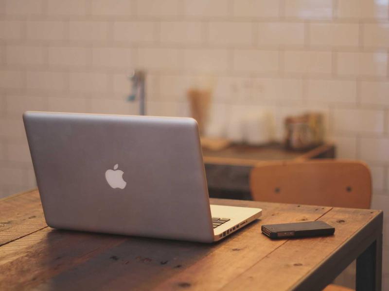 Receipts and a cup of coffee on a wooden counter