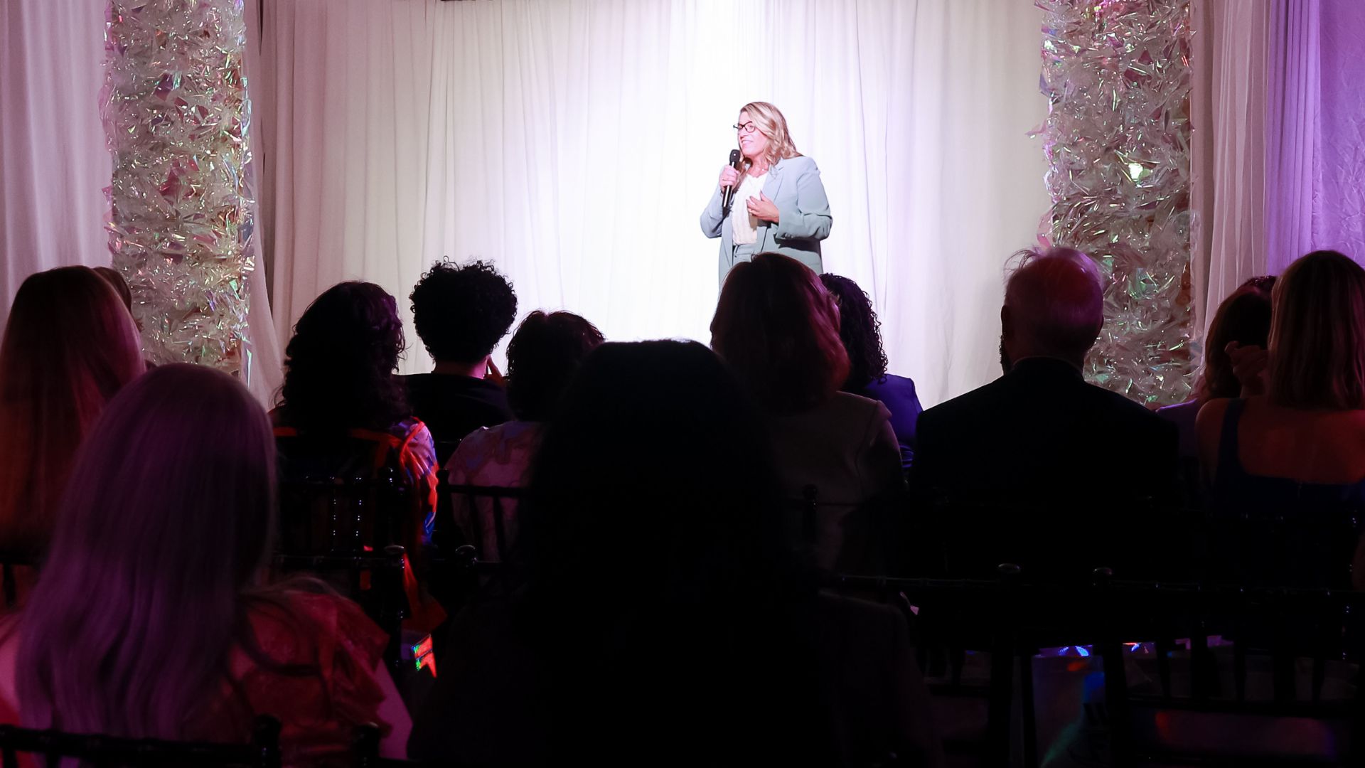 Tamiko McGurk speaking on stage in front of an audience