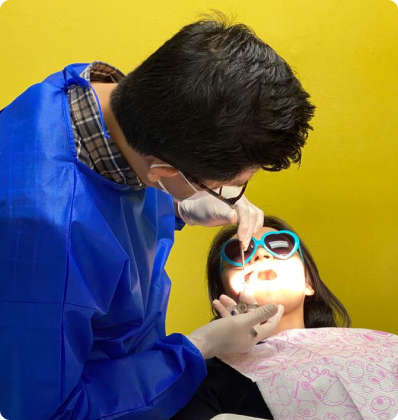 Dentist carrying out a check-up on a young patient