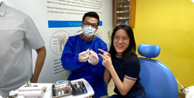 Dentist and patient smiling together in the treatment room