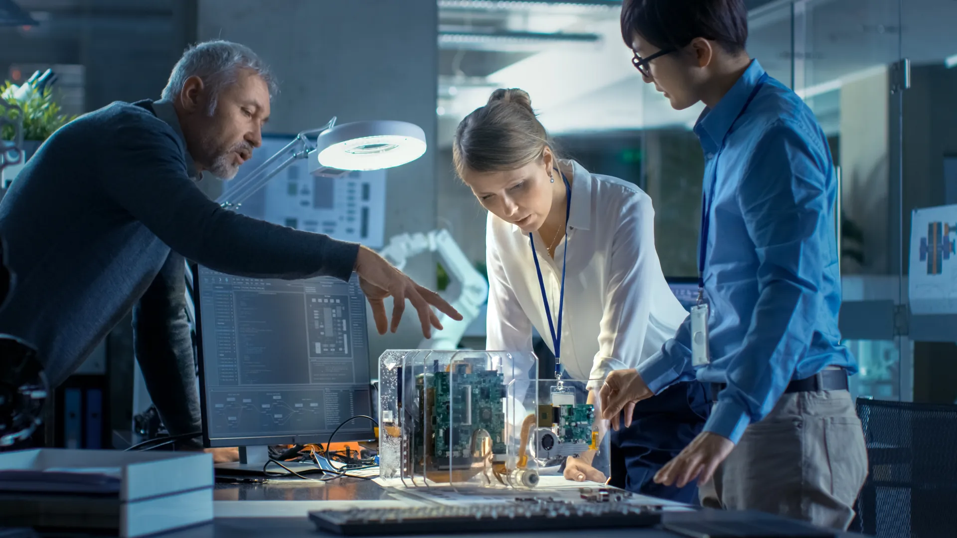 Engineers reviewing control-system hardware in a lab