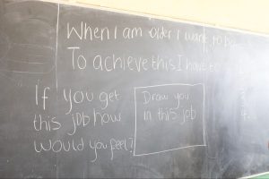 The children are exploring their dream jobs, this exercise is written on a chalk board.