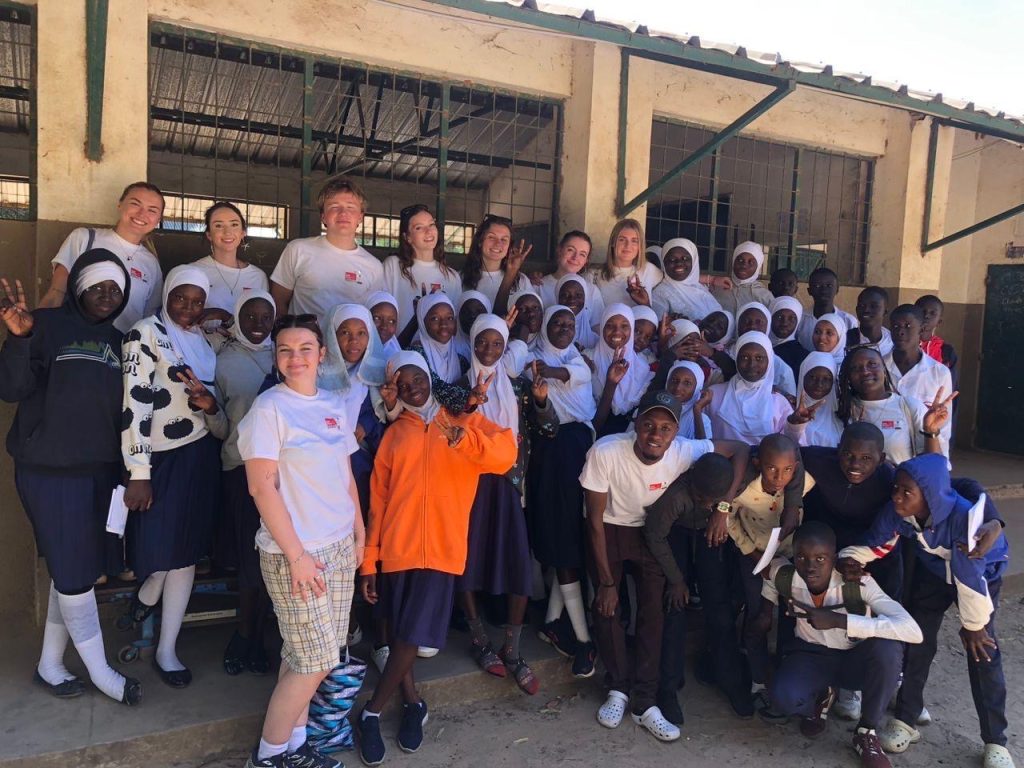 A group photo of all of the students and children.