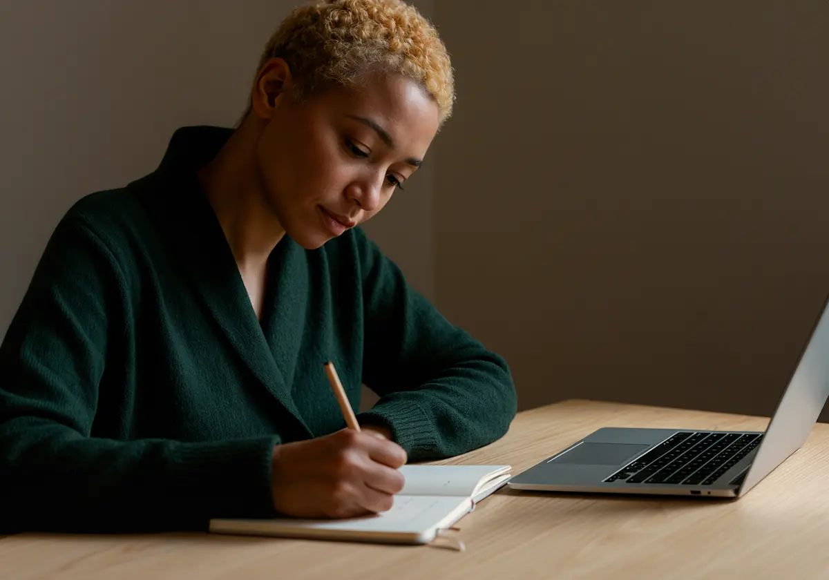 Person in a focused writing session at a desk
