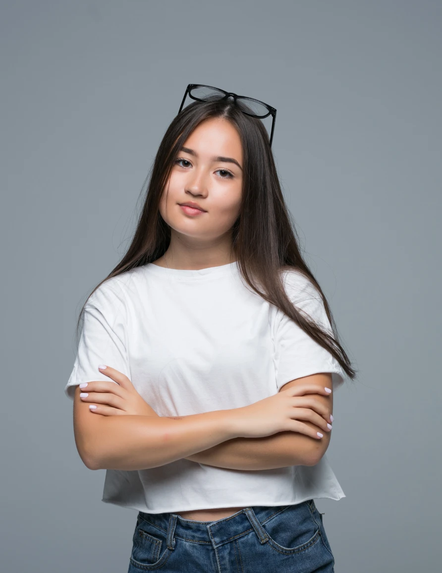 Professional studio headshot portrait of a woman with curly hair against a neutral background