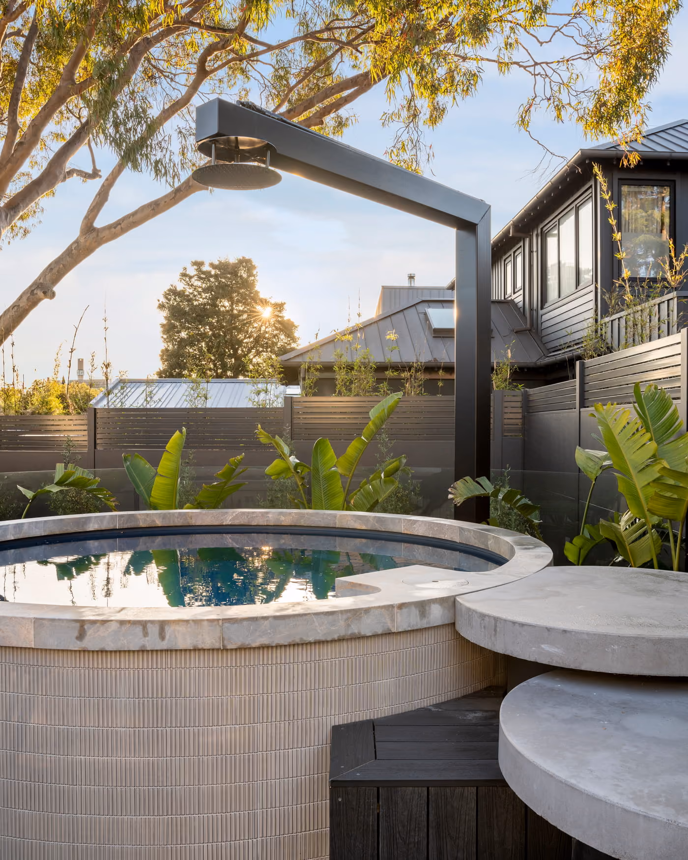 Jacuzzi-style Plungie Arena with custom tiling and matching round steps.