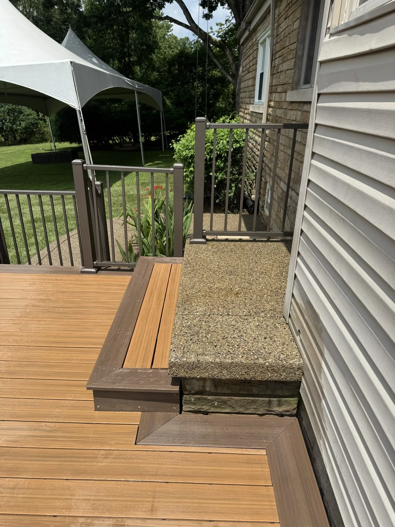 After: finished deck, railing, and stairs with furniture staged