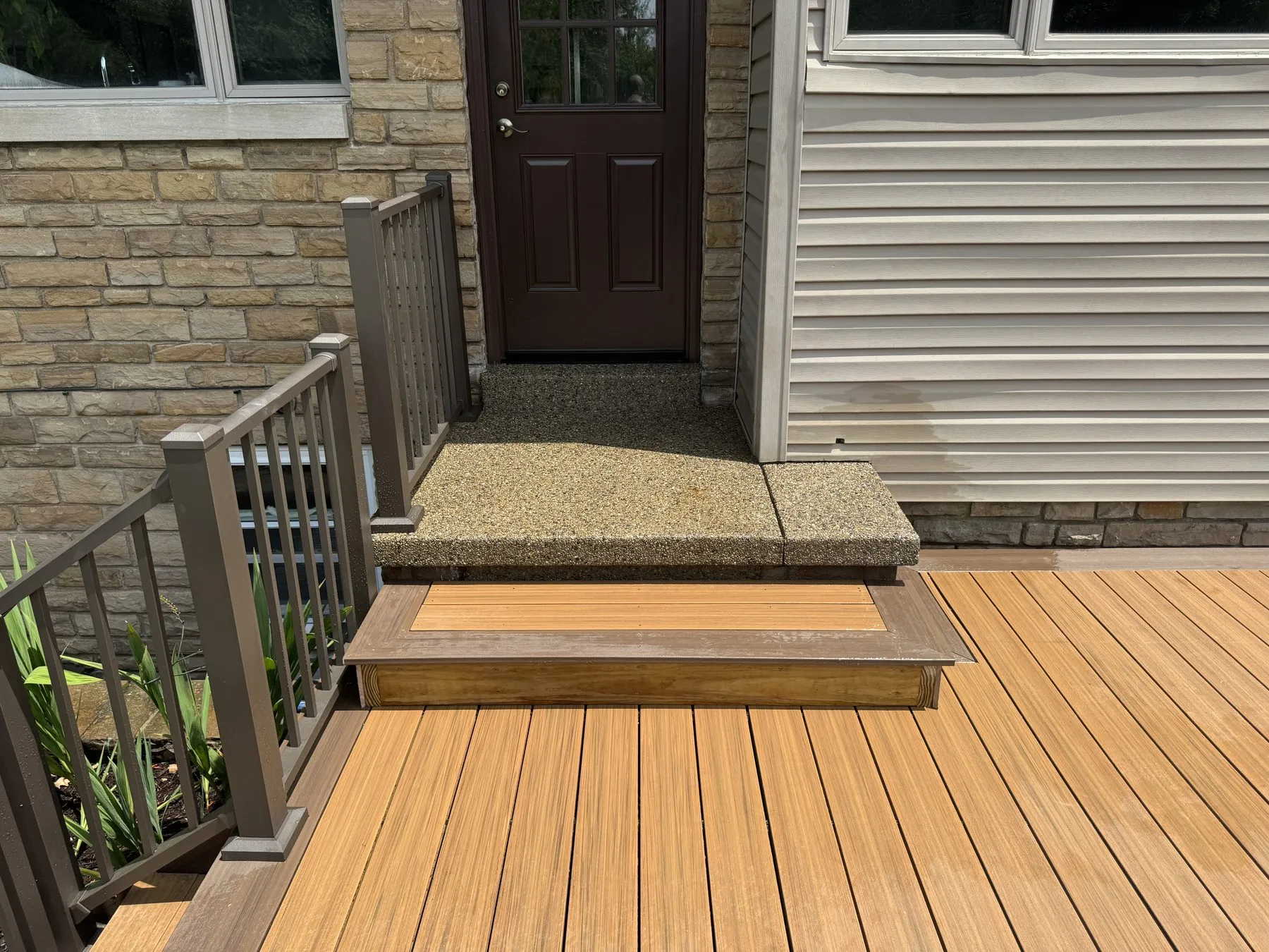 After: finished composite deck step with matching skirt board and set post caps