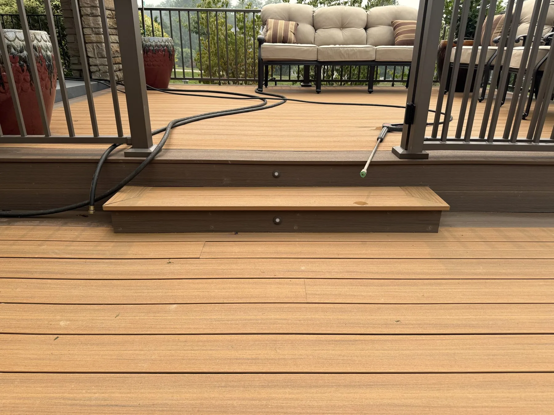Before: lower deck step with exposed low-voltage wiring and unfinished riser edge