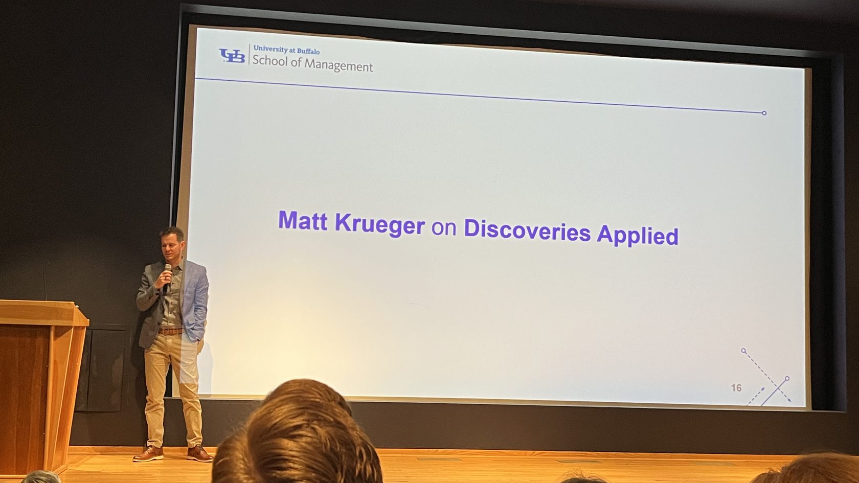 Matt Krueger speaking on stage at the University at Buffalo School of Management