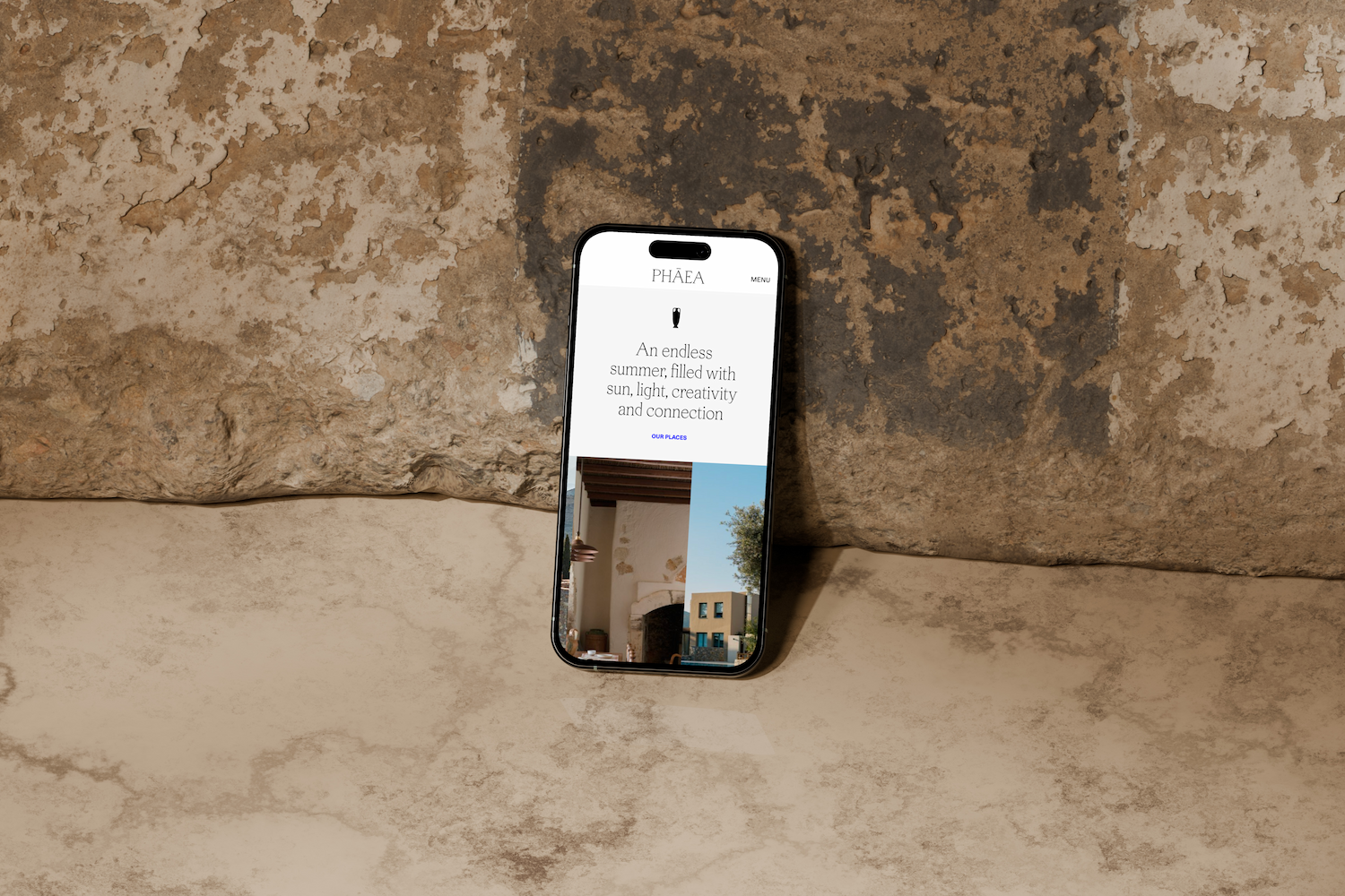 Phāea's mobile homepage on a phone against a weathered stone wall, "An endless summer" tagline