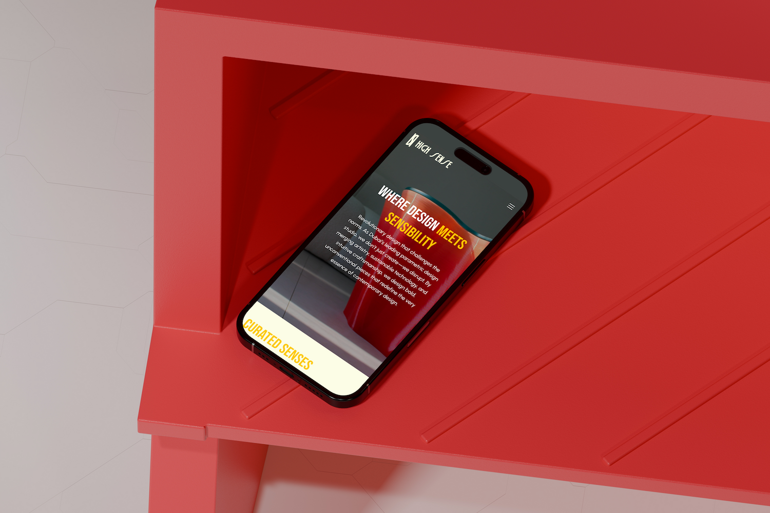 High Sense Studio's mobile homepage displayed on a phone resting on red sculptural furniture, where design meets sensibility