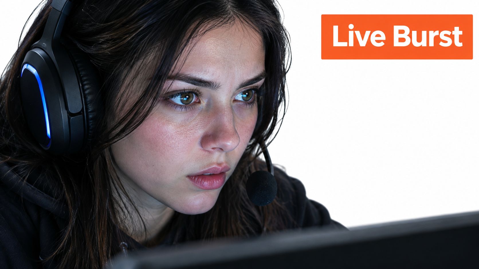 A focused young female gamer wearing a headset with a microphone, playing a video game intensely.