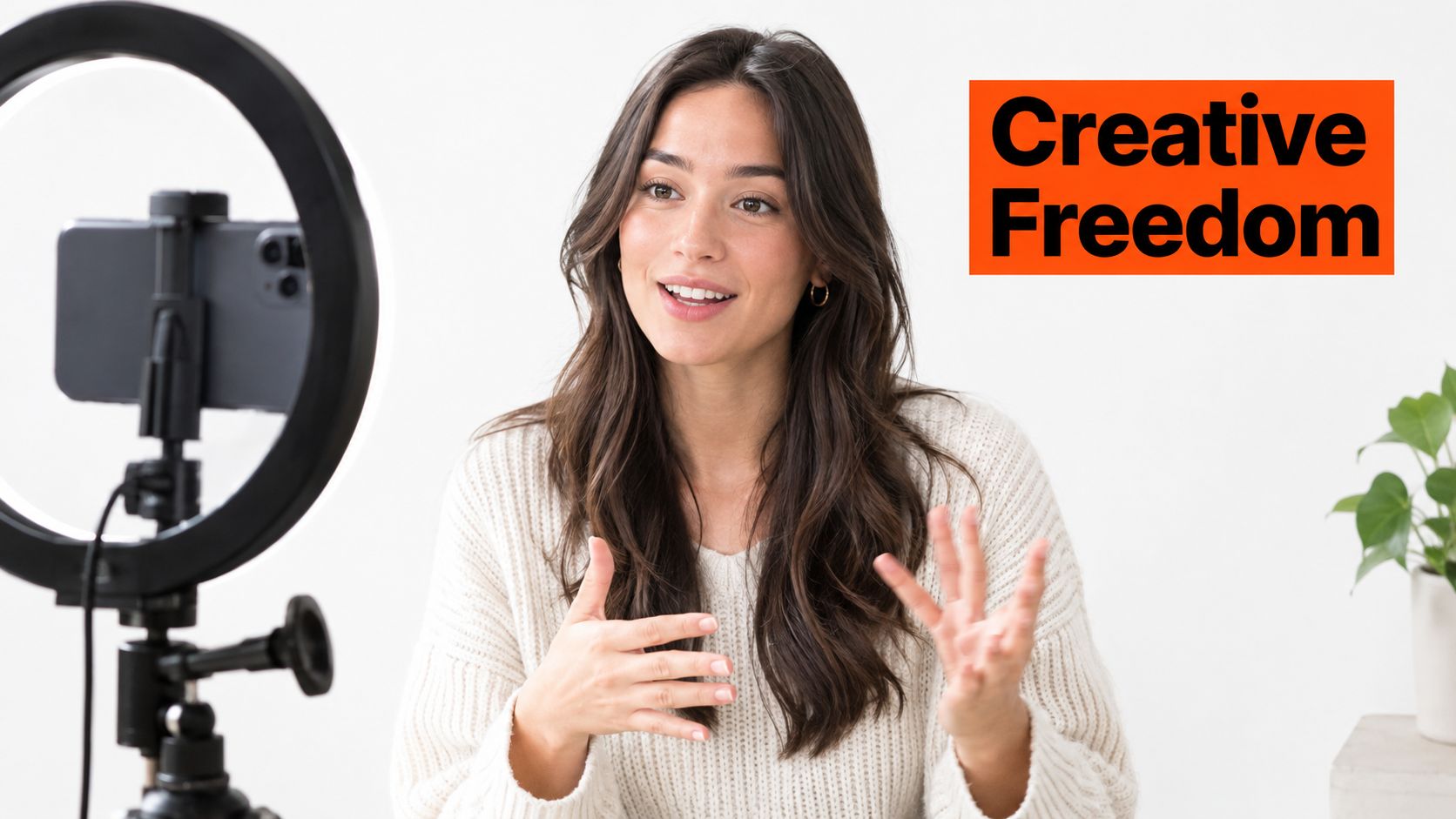 A female content creator recording a video using a smartphone on a ring light stand.