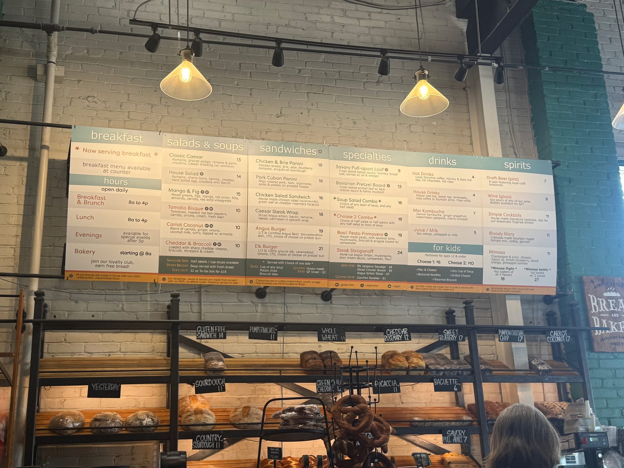 Small-town cafe interior with menu board and bakery shelves