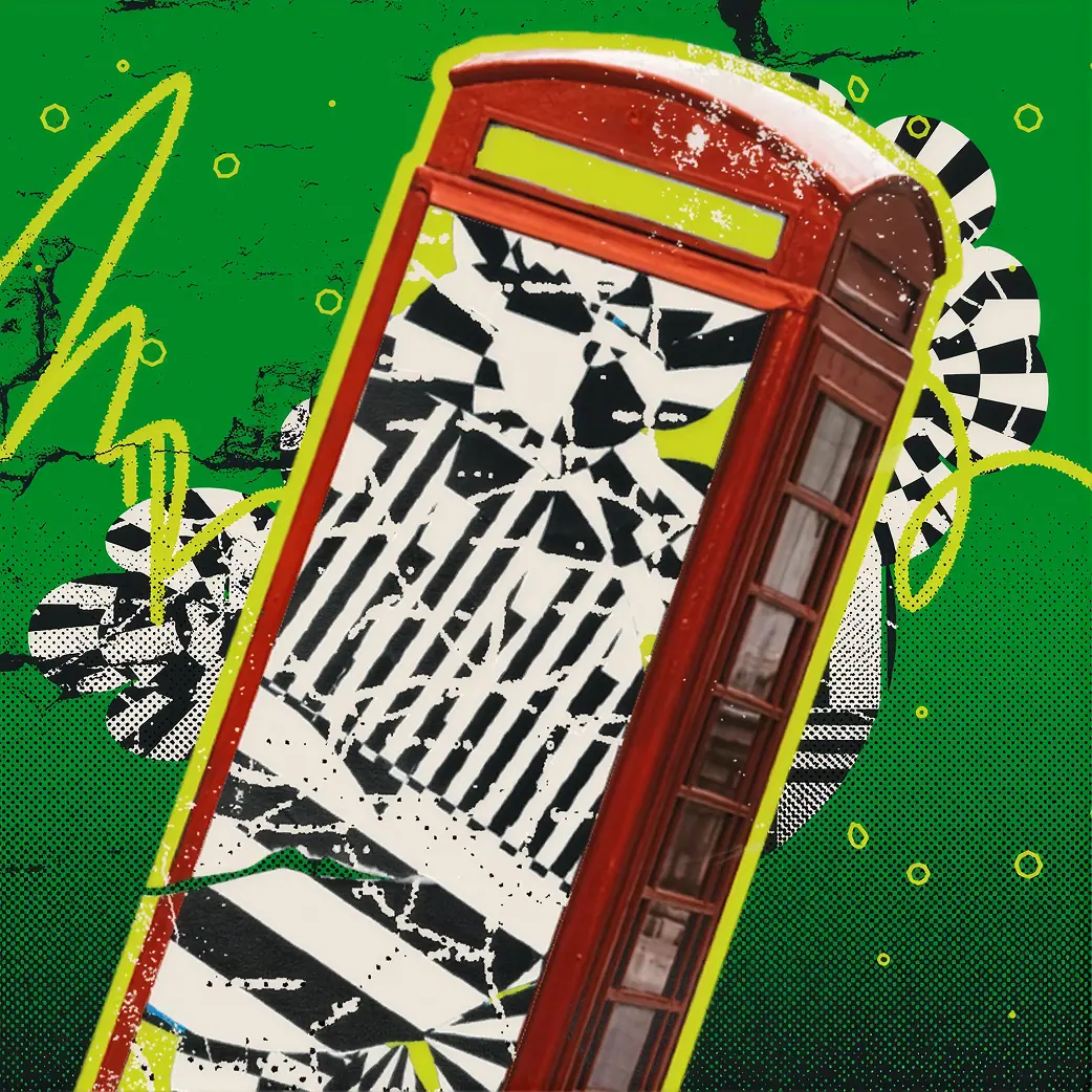 Red vintage phone booth on a green background.