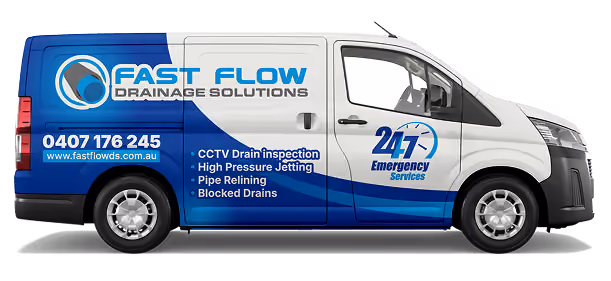 White and blue van with Fast Flow Drainage Solutions logo and services listed on the side.