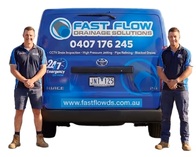Blue Fast Flow Drainage Solutions van with two men in work uniforms standing on each side.