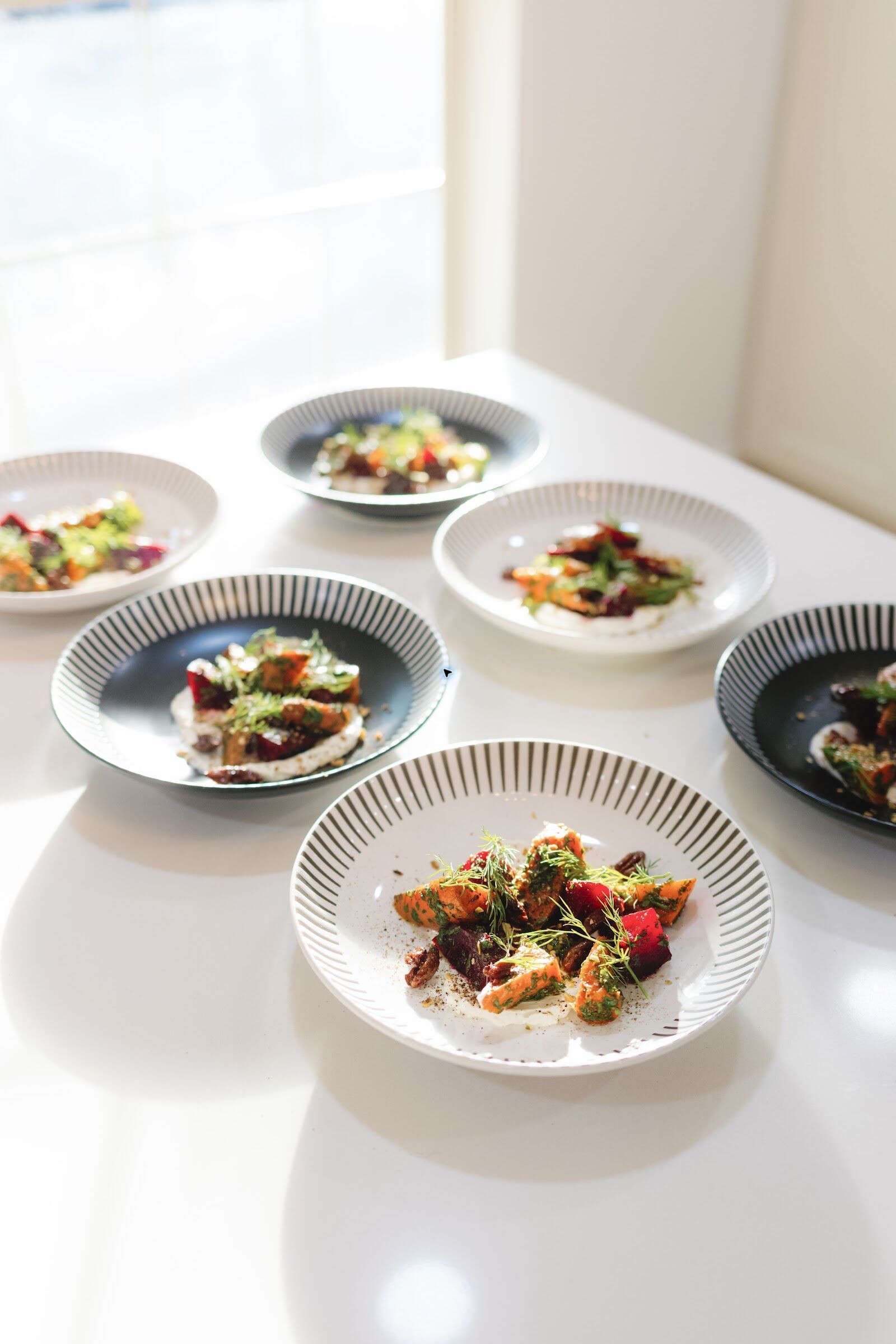 Elevated plated dishes prepared for a private dining experience
