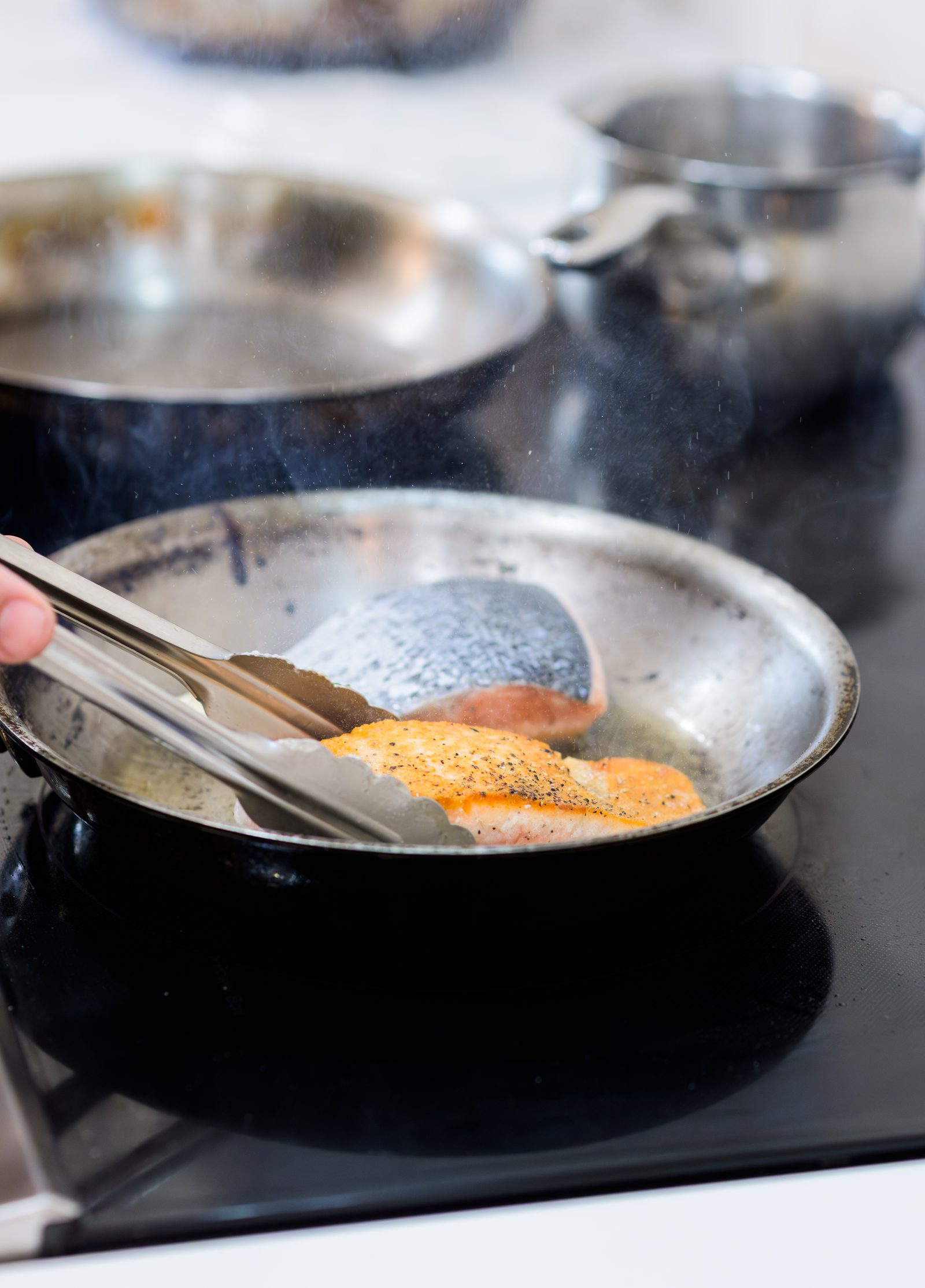 Salmon searing in a pan, a protein-forward dish from an A Perfect Fit private chef