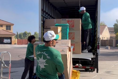 A Jacksons Moving mover securing furniture inside a moving truck, offering professional Glendale, AZ moving services, Phoenix long-distance movers, and full-service packing solutions.