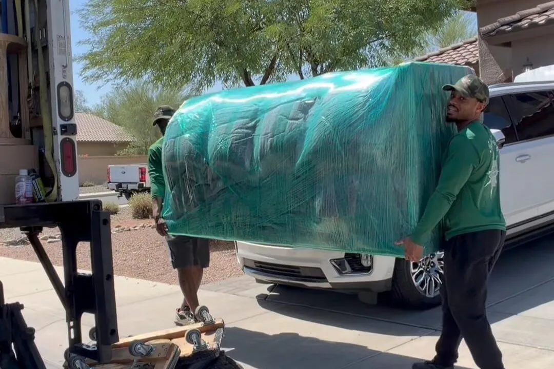 A Jacksons Moving mover securing furniture inside a moving truck, offering professional Glendale, AZ moving services, Phoenix long-distance movers, and full-service packing solutions.