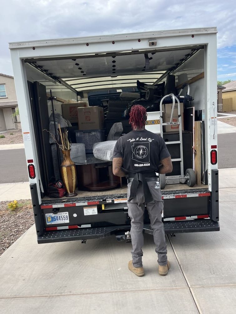 A Jacksons Moving mover securing furniture inside a moving truck, offering professional Glendale, AZ moving services, Phoenix long-distance movers, and full-service packing solutions.