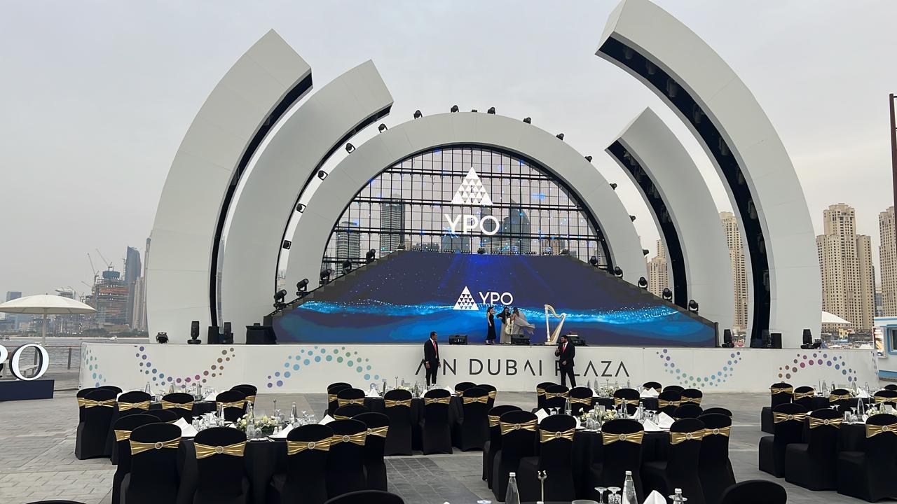 YPO event entrance and stage build with branded LED floor above a banquet floor in Dubai, by Ray Event Management