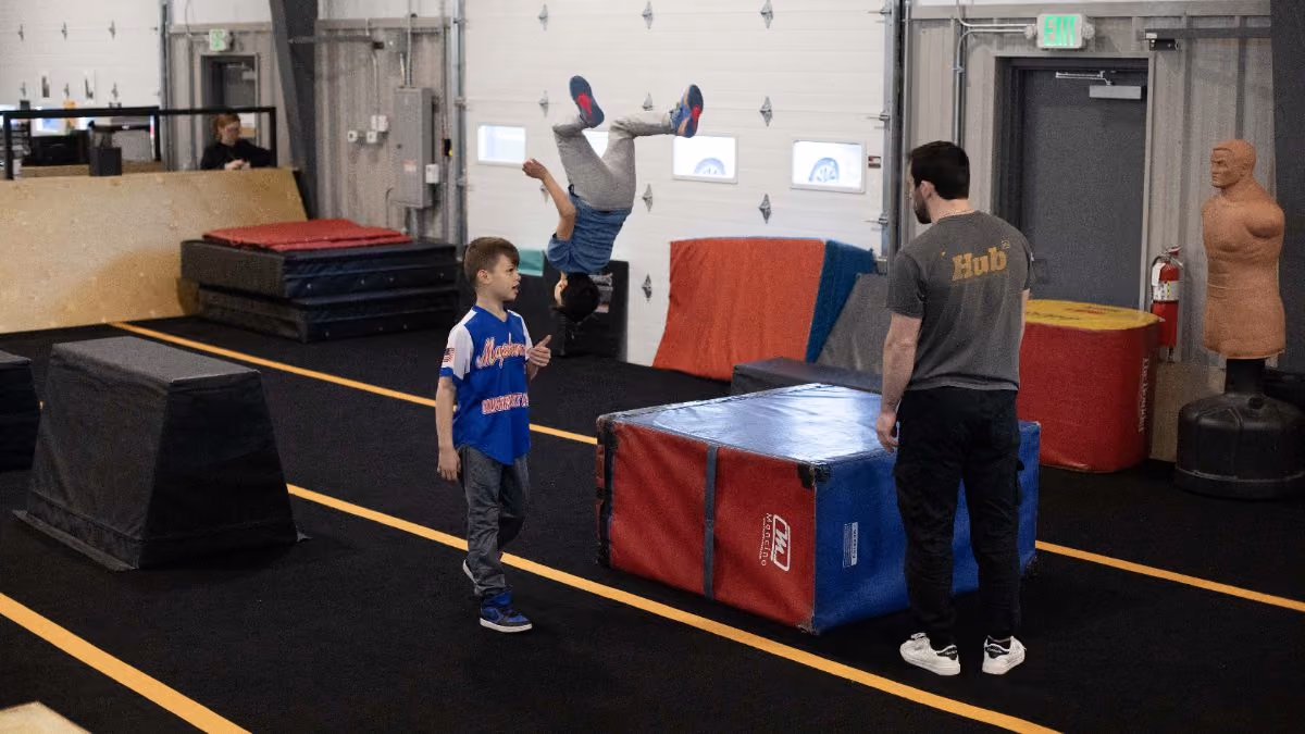 Coach demonstrating a flip at HUB Parkour Norfolk.