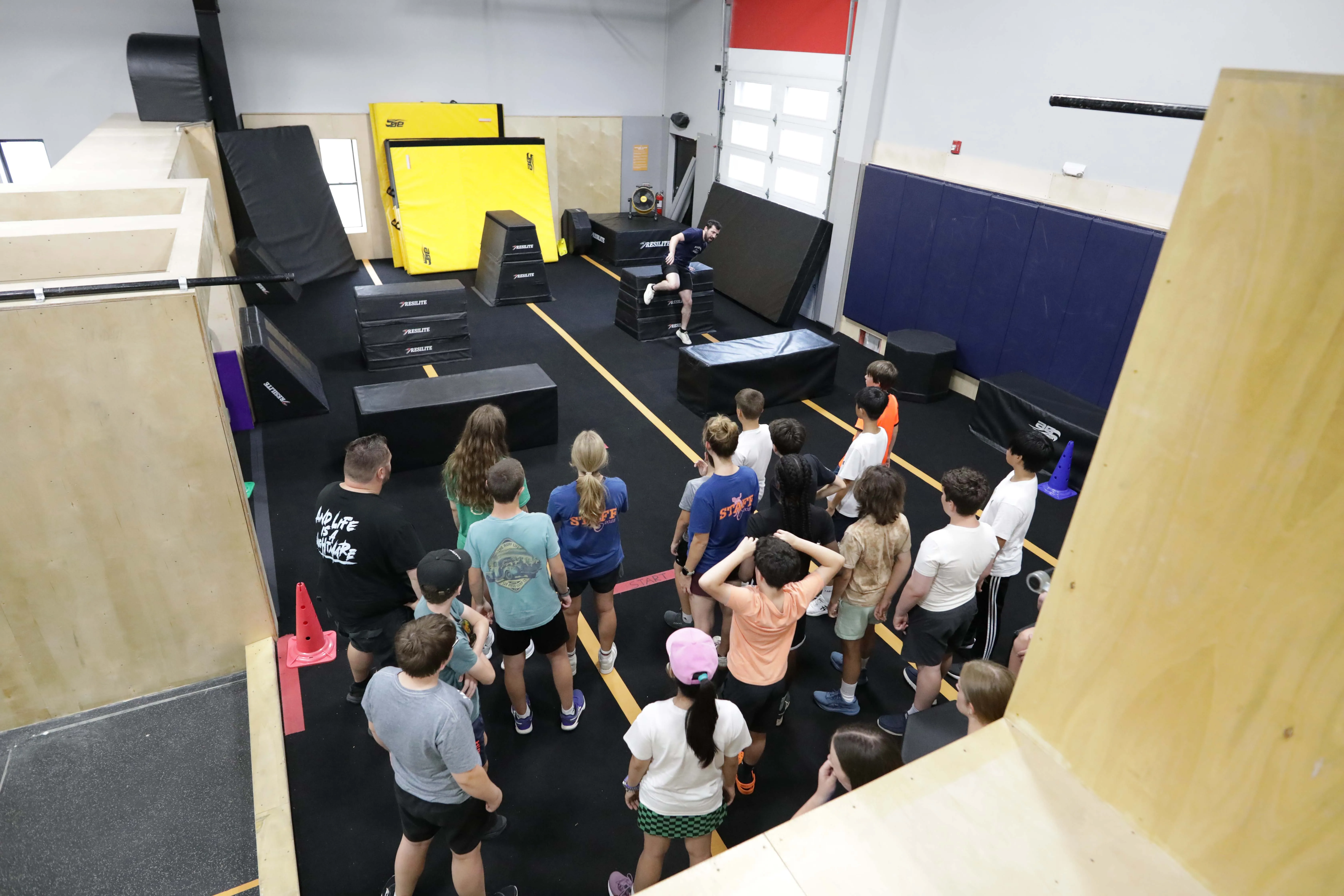 CampHUB athletes gathered with coaches for instructions inside the gym.