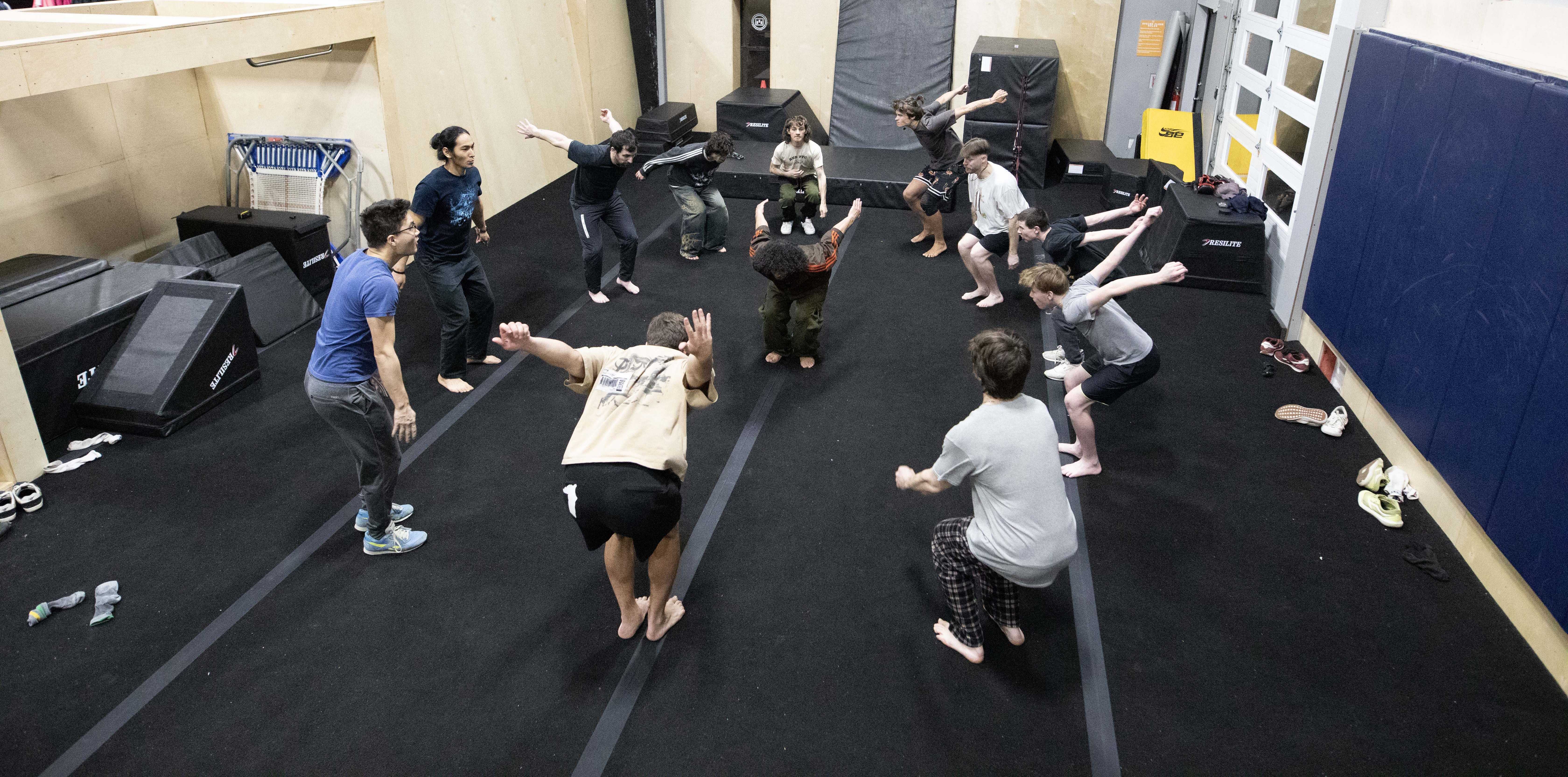 Adult parkour class completing a group warm-up at HUB Parkour Sudbury.