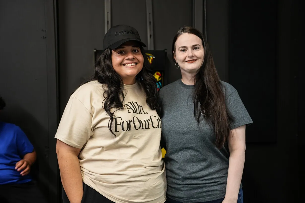 Two women smiling together at prison ministry event