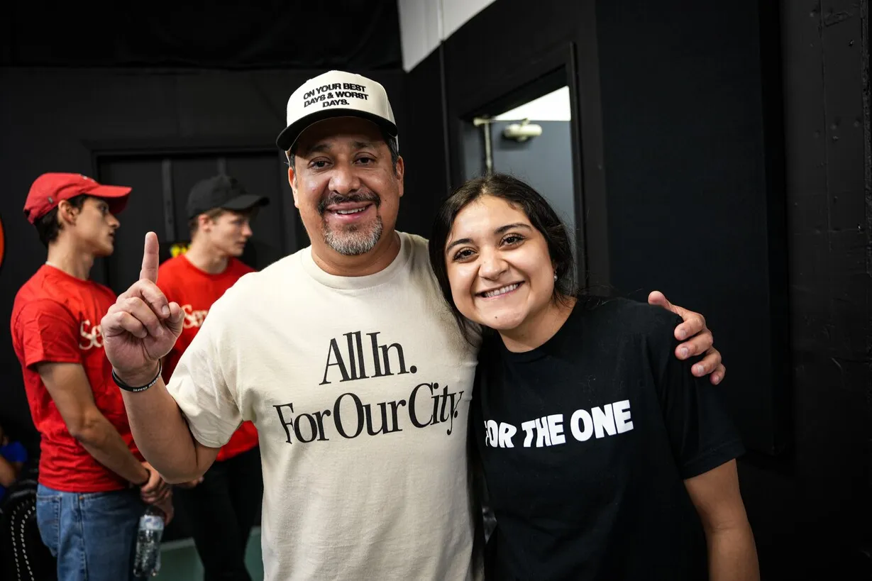 Man and woman smiling wearing ministry T-shirts
