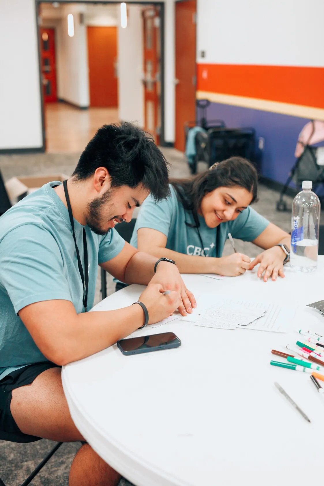 Volunteers filling out paperwork at a training table