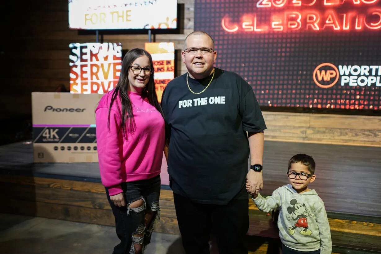 Family posing together at Worthy People celebration event