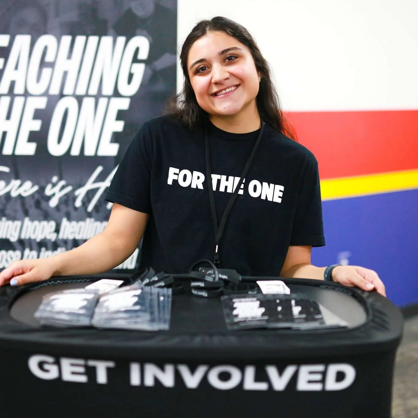Woman smiling at Get Involved volunteer sign-up table
