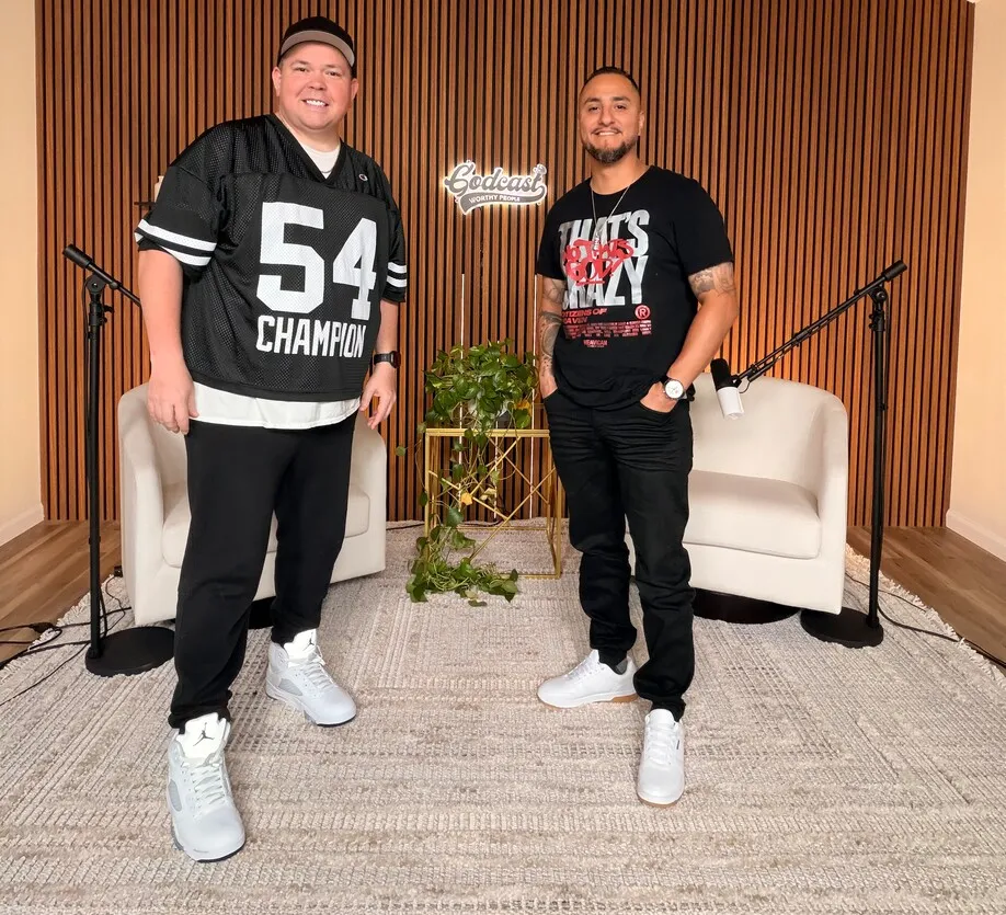 Two men standing together on Worthy People podcast set